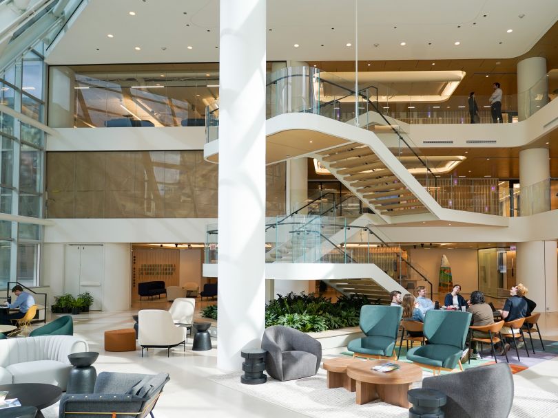 An image of an atrium area in Invenergy’s office where several team members have a discussion at a table